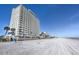 Exterior view of the building from the beach showing multiple units with balconies overlooking the ocean at 89 S Atlantic Ave # 204, Ormond Beach, FL 32176
