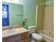 Clean bathroom with shower/tub combo, toilet and vanity at 10730 Se 50Th Ave, Belleview, FL 34420