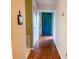 Bright entryway with wood-look floors and teal door at 10730 Se 50Th Ave, Belleview, FL 34420