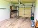 Garage with cabinets, workbench and door at 10730 Se 50Th Ave, Belleview, FL 34420