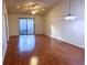 Spacious living room featuring wood-look floors and sliding glass doors at 10730 Se 50Th Ave, Belleview, FL 34420