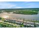 Aerial view of waterfront condos with palms, waterway, and green vegetation at 14 Ocean Palm Villa S # 14, Flagler Beach, FL 32136