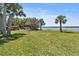 Spacious backyard featuring lush green grass and a serene waterfront view at 14 Ocean Palm Villa S # 14, Flagler Beach, FL 32136