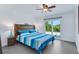 Bedroom with wood headboard and access to outdoor space through a slider door at 14 Ocean Palm Villa S # 14, Flagler Beach, FL 32136