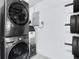 Convenient laundry area featuring a stacked washer and dryer set and a beverage cooler at 14 Ocean Palm Villa S # 14, Flagler Beach, FL 32136