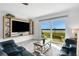 Bright living room with contemporary furniture, built-in shelving, and scenic river views through sliding glass doors at 14 Ocean Palm Villa S # 14, Flagler Beach, FL 32136