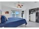 Bright main bedroom featuring a ceiling fan, slider door with a view, and an organized closet system at 14 Ocean Palm Villa S # 14, Flagler Beach, FL 32136