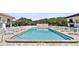 Community pool area with poolside lounge chairs and a safety fence at 14 Ocean Palm Villa S # 14, Flagler Beach, FL 32136