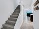 Modern staircase leading to the living area with sliding glass doors and water views at 14 Ocean Palm Villa S # 14, Flagler Beach, FL 32136