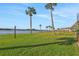 Scenic waterfront property with palm trees and lush green lawn at 14 Ocean Palm Villa S # 14, Flagler Beach, FL 32136
