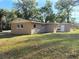 Newly constructed light brown single-story house with detached shed at 930 Nw 6Th Terrace Ter, Ocala, FL 34475