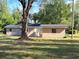 Rear view of a newly constructed light brown single-story house at 930 Nw 6Th Terrace Ter, Ocala, FL 34475