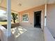 Covered front porch with light brown stucco exterior and view of yard at 930 Nw 6Th Terrace Ter, Ocala, FL 34475