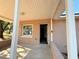 Covered front porch with light brown stucco exterior at 930 Nw 6Th Terrace Ter, Ocala, FL 34475