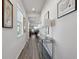 Bright hallway with hardwood floors and modern light fixtures at 6043 Sw 93Rd Cir, Ocala, FL 34481