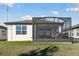 Home exterior showcasing a screened patio and yard at 6043 Sw 93Rd Cir, Ocala, FL 34481