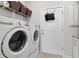 Bright laundry room with washer, dryer, and storage at 6043 Sw 93Rd Cir, Ocala, FL 34481