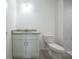 This bath has a nice vanity with gray countertops, gray cabinets and a toilet at 8873 Sw 139Th Place Rd, Ocala, FL 34473