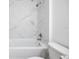 Clean bathroom featuring tub with marble-look tile surround at 8873 Sw 139Th Place Rd, Ocala, FL 34473