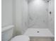 Modern bath has a toilet and a spacious shower with tile walls at 8873 Sw 139Th Place Rd, Ocala, FL 34473