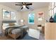 Light and airy bedroom with wood-look floors and a ceiling fan at 8873 Sw 139Th Place Rd, Ocala, FL 34473