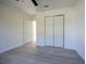 Well-lit bedroom features vinyl floors, closet, and fresh paint at 8873 Sw 139Th Place Rd, Ocala, FL 34473