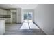 Modern kitchen showcases sleek white cabinets, stainless steel appliances, and abundant natural light through a sliding glass door at 8873 Sw 139Th Place Rd, Ocala, FL 34473