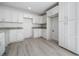 Well-equipped kitchen features ample white cabinetry, granite countertops, and modern fixtures for efficient meal preparation at 8873 Sw 139Th Place Rd, Ocala, FL 34473