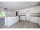 Bright kitchen features white cabinets, granite countertops, stainless steel faucet and vinyl floors at 8873 Sw 139Th Place Rd, Ocala, FL 34473