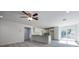 Spacious living room boasting modern light fixture, wood-look flooring, and an open layout to the kitchen and backyard at 8873 Sw 139Th Place Rd, Ocala, FL 34473