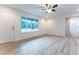 Living room features vinyl flooring, a ceiling fan and access to bathroom at 8873 Sw 139Th Place Rd, Ocala, FL 34473