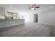 Open-concept living area features wood-look flooring, modern lighting, and a breakfast bar overlooking the kitchen at 8873 Sw 139Th Place Rd, Ocala, FL 34473