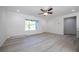 Bright and airy living room offering wood-look floors, a large window, and seamless access to other rooms at 8873 Sw 139Th Place Rd, Ocala, FL 34473