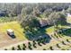 Aerial view of a house on a large lot with lush trees and a fenced yard at 16385 Nw 112Th Ct, Reddick, FL 32686