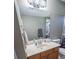 Clean bathroom with wood vanity and large mirror at 16385 Nw 112Th Ct, Reddick, FL 32686