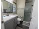 Modern bathroom with gray vanity, a walk-in shower, and white toilet at 16385 Nw 112Th Ct, Reddick, FL 32686