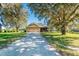 House exterior showcasing covered patio and spacious yard at 16385 Nw 112Th Ct, Reddick, FL 32686
