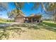House exterior with covered patio, attached garage, and spacious yard at 16385 Nw 112Th Ct, Reddick, FL 32686