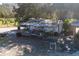 Aerial view of a rustic farm shed with equipment and storage at 16385 Nw 112Th Ct, Reddick, FL 32686