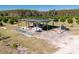 Aerial view of an irrigation system and storage tanks in a citrus grove at 16385 Nw 112Th Ct, Reddick, FL 32686