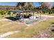 Aerial view of an irrigation system and storage tanks in a citrus grove at 16385 Nw 112Th Ct, Reddick, FL 32686