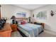 Cozy bedroom with wood furniture and striped bedding at 5315 Nw 25Th Loop, Ocala, FL 34482