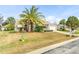 Single story home with palm tree and grassy yard at 5315 Nw 25Th Loop, Ocala, FL 34482