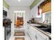 White kitchen with black countertops and a view into the dining area at 5315 Nw 25Th Loop, Ocala, FL 34482