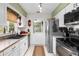 White kitchen with stainless steel appliances and double sink at 5315 Nw 25Th Loop, Ocala, FL 34482