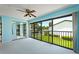 Bedroom with mirrored closet doors and sliding glass doors leading to balcony at 1 Tomoka Oaks Blvd # 102, Ormond Beach, FL 32174