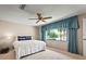 Main bedroom with window, ceiling fan and carpet at 1 Tomoka Oaks Blvd # 102, Ormond Beach, FL 32174