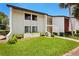 Front view of condo building showcasing landscaping and building features at 1 Tomoka Oaks Blvd # 102, Ormond Beach, FL 32174