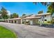 Condo building with covered carport parking and lush landscaping at 1 Tomoka Oaks Blvd # 102, Ormond Beach, FL 32174