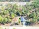 Aerial view of a house nestled in a wooded lot at 5919 Sw 124Th Terrace Rd, Ocala, FL 34481